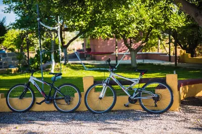 three bikes parked against a wall in a park at Villa Marqua in Kalavárda