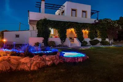 a house with a pool in the yard at night at Villa Marqua in Kalavárda