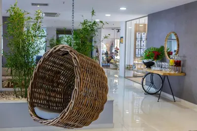a wicker chair in the middle of a lobby at Leonardo Kolymbia Resort Rhodes in Kolimbia