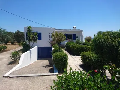 a white house with a ramp in front of it at Afantou beach house in Kolimbia