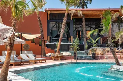 a swimming pool with palm trees and a resort at Venezia Resort Hotel & Spa in Faliraki