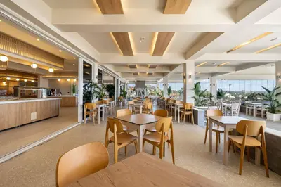 a restaurant with tables and chairs and a cafeteria at Venezia Resort Hotel & Spa in Faliraki