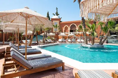 a swimming pool with lounge chairs and umbrellas at Venezia Resort Hotel & Spa in Faliraki