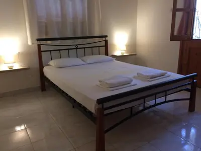 a bed in a room with two towels on it at Panorama Thea in Symi