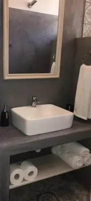 a bathroom with a sink and a mirror and towels at Panorama Thea in Symi