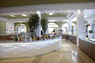 a restaurant with a large white counter in a building at Sunshine Rhodes in Ialyssos