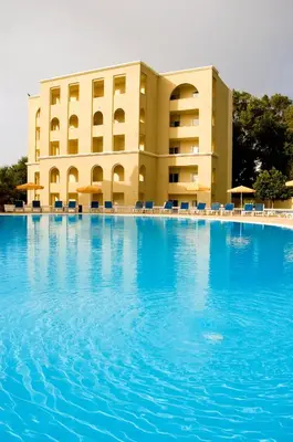a large swimming pool in front of a hotel at Sunshine Rhodes in Ialyssos