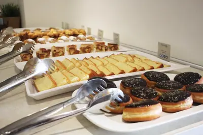 a buffet with many different types of donuts on display at Pefkos Village Resort in Pefki Rhodes