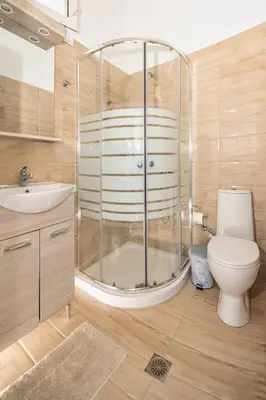 a bathroom with a shower and a toilet and a sink at Salora Studio-Apartments in Archangelos