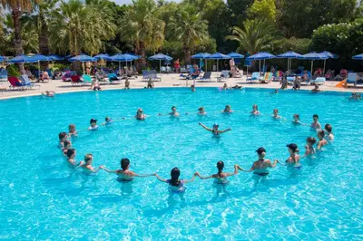 a group of people in the water at a swimming pool at Kresten Palace Hotel in Kallithea Rhodes