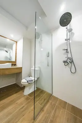 a bathroom with a shower and a toilet and a sink at Kresten Palace Hotel in Kallithea Rhodes