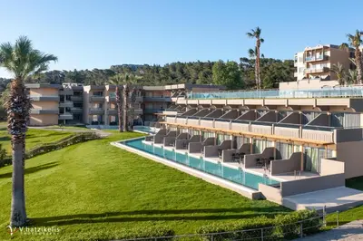 a resort with a swimming pool and palm trees at Kresten Palace Hotel in Kallithea Rhodes