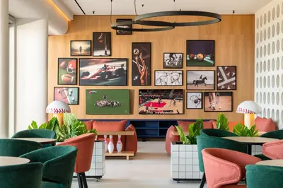 a restaurant with colorful chairs and pictures on the wall at Kresten Palace Hotel in Kallithea Rhodes
