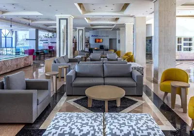 a lobby with couches and tables and chairs at Kresten Palace Hotel in Kallithea Rhodes