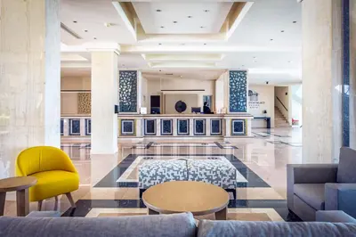 a lobby with couches and a table and chairs at Kresten Palace Hotel in Kallithea Rhodes