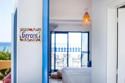 a room with a bed and a view of the ocean at Dimitra Boutique Rooms in Faliraki