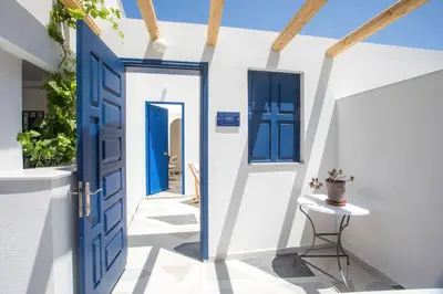 an open blue door in a white house at Dimitra Boutique Rooms in Faliraki