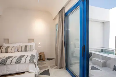 a bedroom with a bed and a glass door at Dimitra Boutique Rooms in Faliraki
