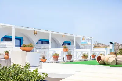 a white building with plants in front of it at Dimitra Boutique Rooms in Faliraki