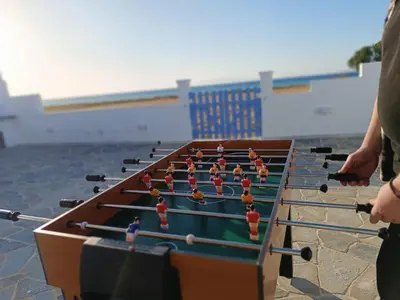 a group of people playing a game on a table at Nautilus Beach House in Paradeísion