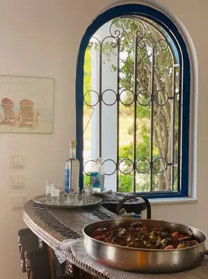 a table with a tray of food in front of a window at Nautilus Beach House in Paradeísion