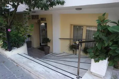 a entrance to a building with potted plants at Royal Aparthotel City Centre in Rhodes Town