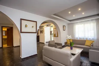 a living room with a couch and a table at Royal Aparthotel City Centre in Rhodes Town