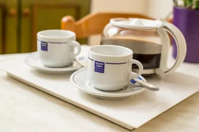 two coffee cups on a tray on a table at Royal Aparthotel City Centre in Rhodes Town