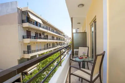 a balcony with a table and chairs on a building at Royal Aparthotel City Centre in Rhodes Town