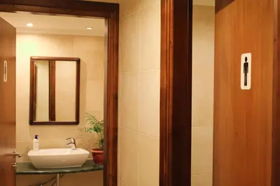 a bathroom with a sink and a mirror at Royal Aparthotel City Centre in Rhodes Town