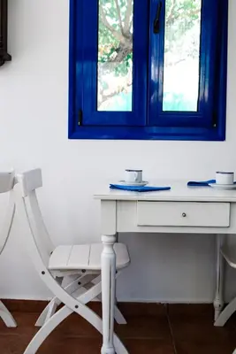 a white desk with a chair and a mirror at Katikies Studios & Apartments in Lardos