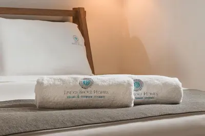 two towels sitting on top of a bed at Lindos Shore Junior Suite in Líndos