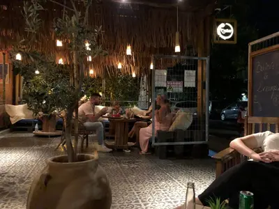 a group of people sitting at a table in a restaurant at Rhodes Backpackers Boutique Hostel and Apartments in Rhodes Town