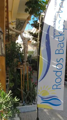 a surfboard on a stand in front of a building at Rhodes Backpackers Boutique Hostel and Apartments in Rhodes Town