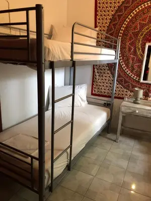 a bedroom with two bunk beds in a room at Rhodes Backpackers Boutique Hostel and Apartments in Rhodes Town