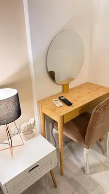 a wooden desk with a mirror on top of it at Rhodes Backpackers Boutique Hostel and Apartments in Rhodes Town