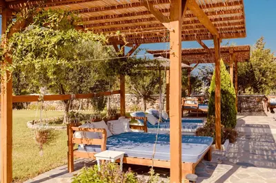 a bed in a gazebo in a garden at Caesars Gardens Hotel & Spa - Adults Only in Líndos