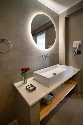 a bathroom with a white sink and a mirror at Bella Vista Stegna in Archangelos