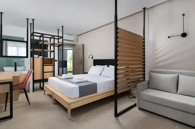 a bedroom with a bed and a chair and a table at Paralos Rodos Lifestyle in Kolimbia