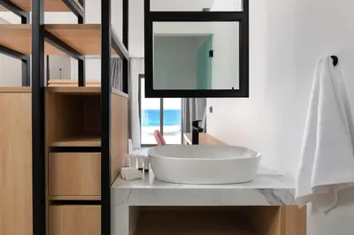 a bathroom with a white sink and a mirror at Paralos Rodos Lifestyle in Kolimbia