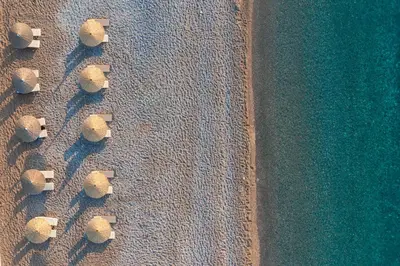 an overhead view of a group of umbrellas on the beach at Paralos Rodos Lifestyle in Kolimbia