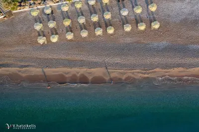 an overhead view of a beach with umbrellas and the ocean at Paralos Rodos Lifestyle in Kolimbia
