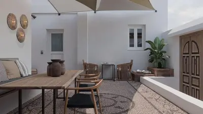 a dining room with a table and chairs and a tub at F Fine Suites - Adults Only in Líndos
