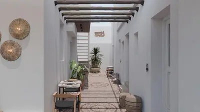 a hallway with a table and chairs in a building at F Fine Suites - Adults Only in Líndos