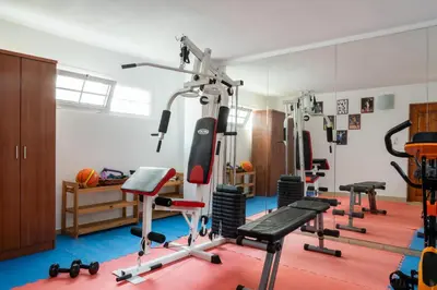 a gym with several exercise equipment in a room at Afantou Golf Luxury Villa in Afantou