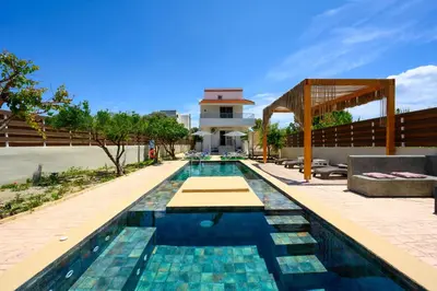 a swimming pool in front of a villa at Afantou Golf Luxury Villa in Afantou