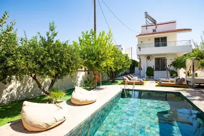 a swimming pool in the backyard of a house at Afantou Golf Luxury Villa in Afantou