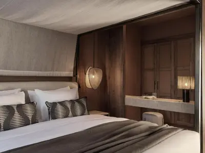 a bedroom with a large bed with white sheets and pillows at Aulus Lindos Rhodes, All-Inclusive Resort, Curio Collection by Hilton in Kiotari