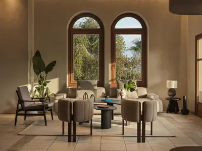 a living room with two windows and a couch and chairs at Aulus Lindos Rhodes, All-Inclusive Resort, Curio Collection by Hilton in Kiotari
