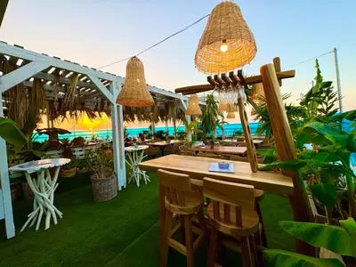 a restaurant with tables and chairs and lights at Hotel Parthenon Rodos city in Rhodes Town